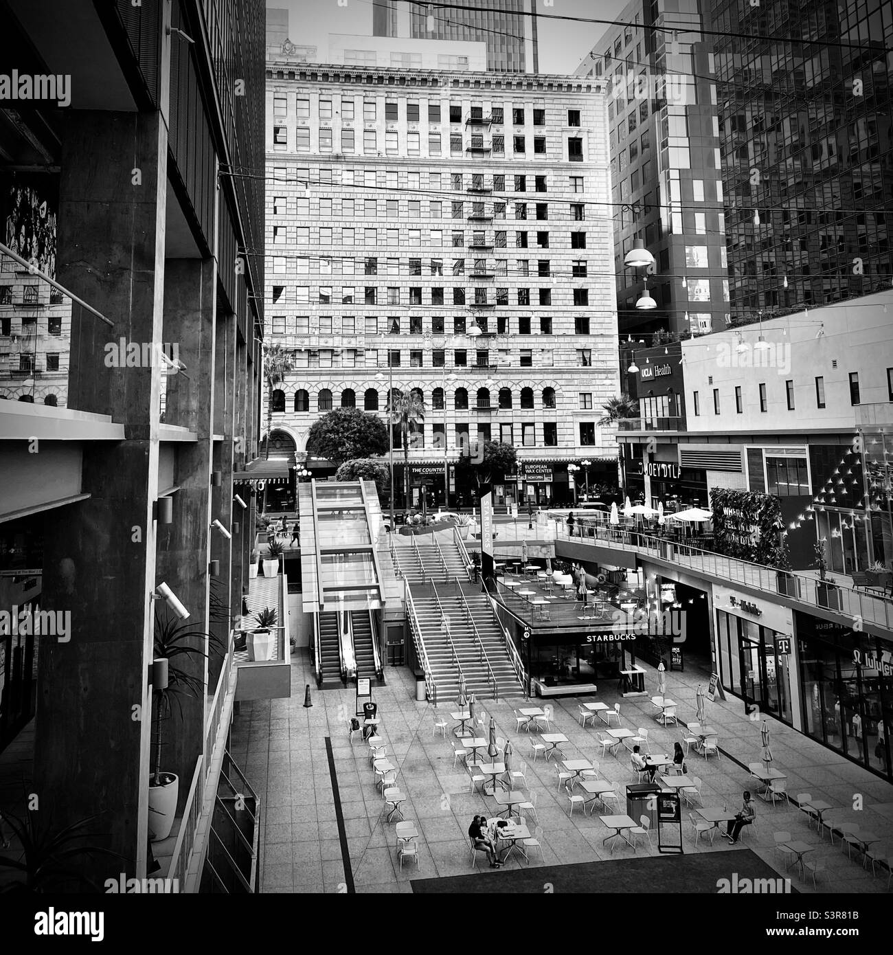 LOS ANGELES, CA, JUL 2021: looking across courtyard at The Bloc, retail and business area in Downtown, black and white - Smartphone Captured Stock Image