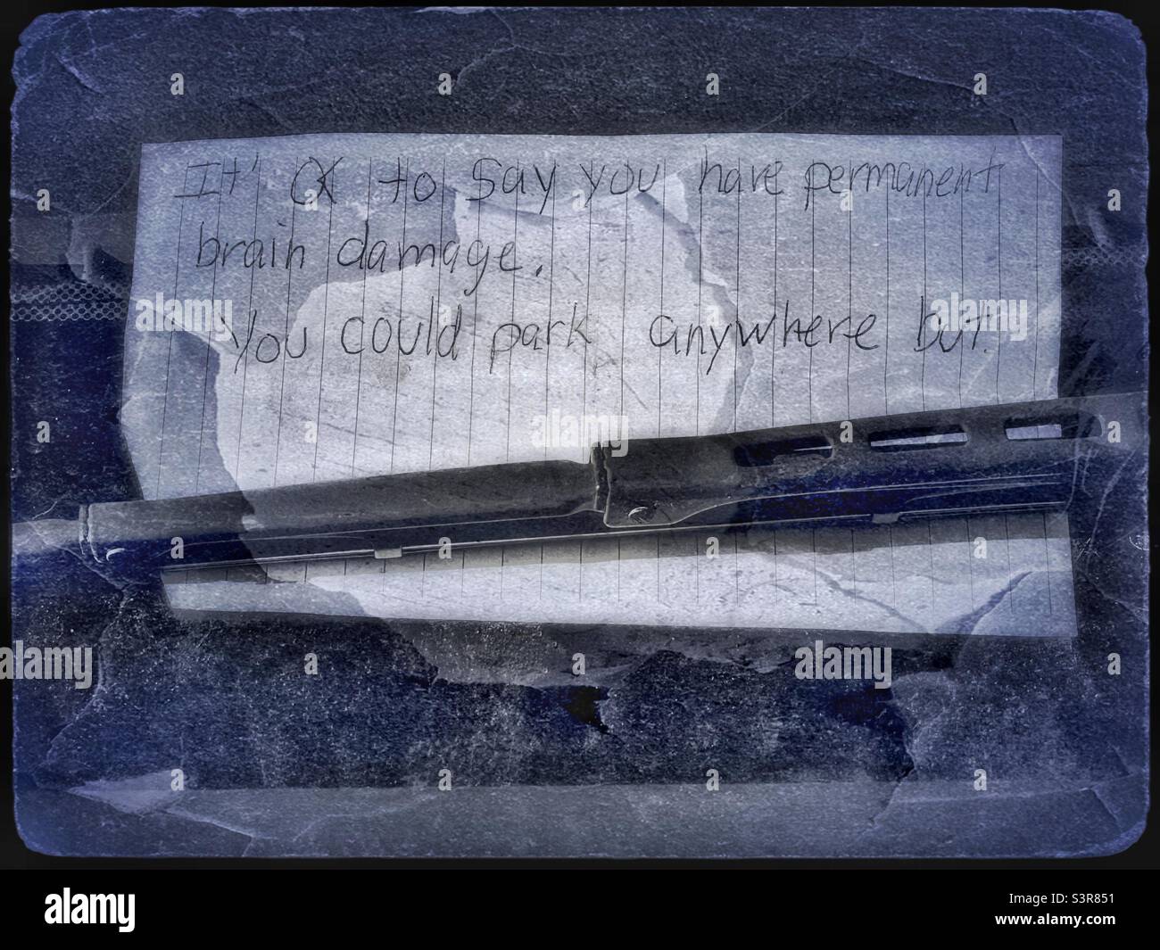 Nasty note left on my car windshield because apparently they were upset because I parked where they wanted to, even though I didn’t see their name on it, - Smartphone Captured Stock Image