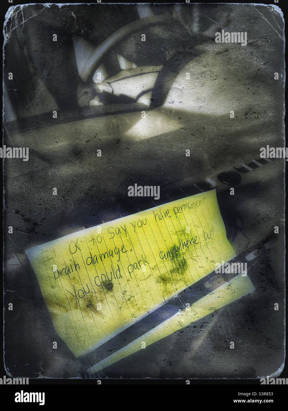 Nasty note left on my car windshield because apparently they were upset because I parked where they wanted to, even though I didn’t see their name on it, - Smartphone Captured Stock Image