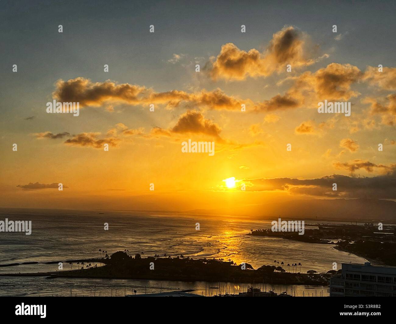 Golden sunset at Waikiki Beach, Honolulu, Oahu, Hawaii USA - Smartphone Captured Stock Image