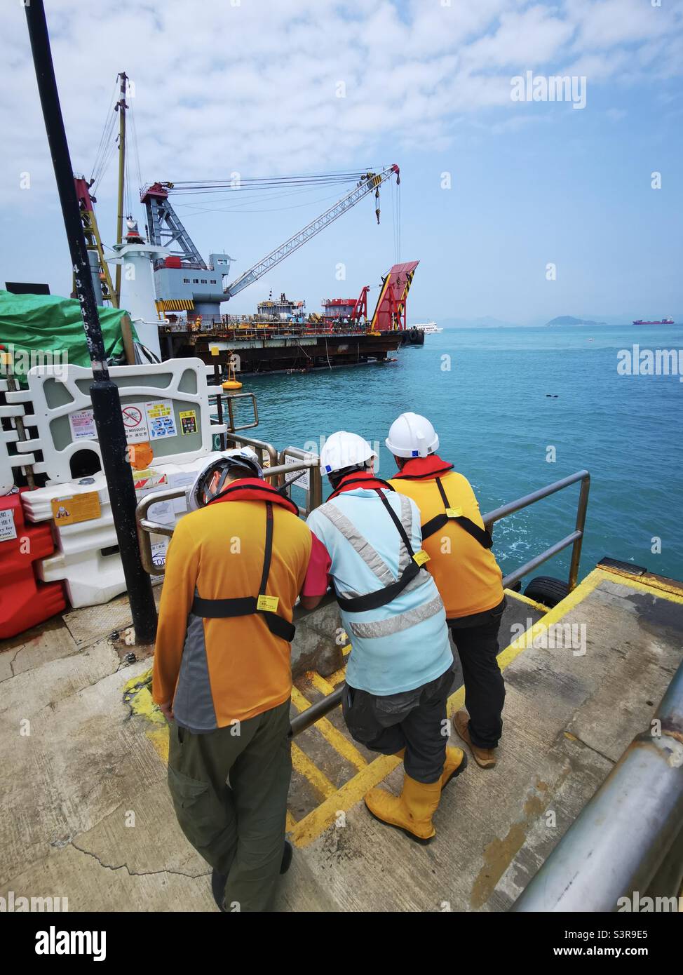 Construction workers at the Pak Kok pier, Lamma island,Hong Kong. Stock Photo