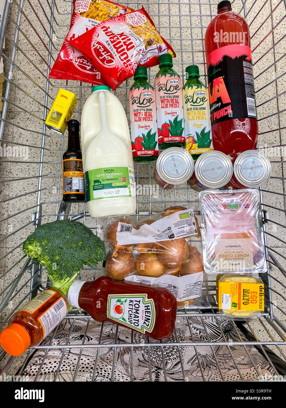Groceries on a supermarket trolley. Stock Photo