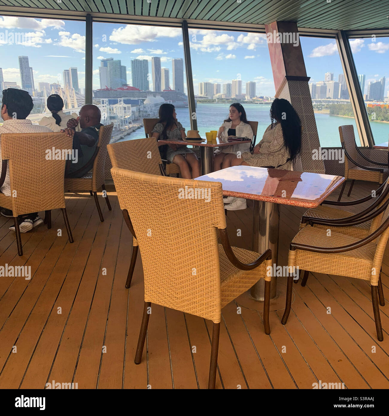 March, 2022, people sitting at tables at the buffet on the Carnival Conquest while in port in Miami, Florida, prior to sailing away on a cruise to the Bahamas - Smartphone Captured Stock Image
