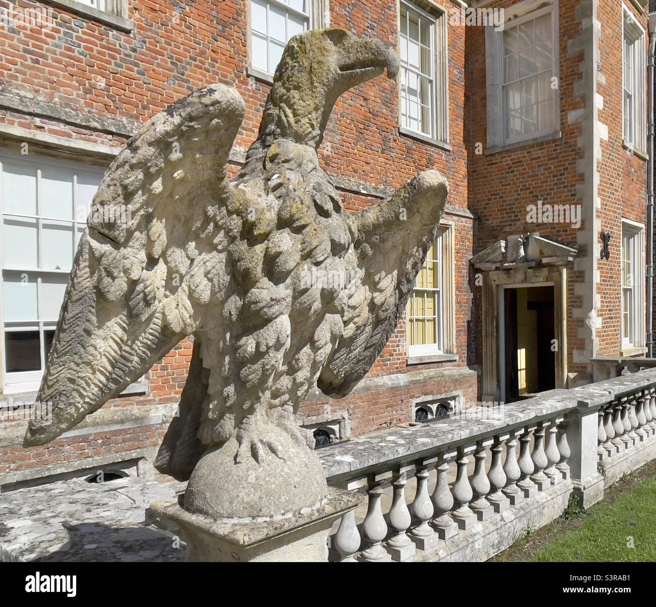 A carved stone eagle beside the front door of The Vyne, a country house in Hampshire UK Stock Photo