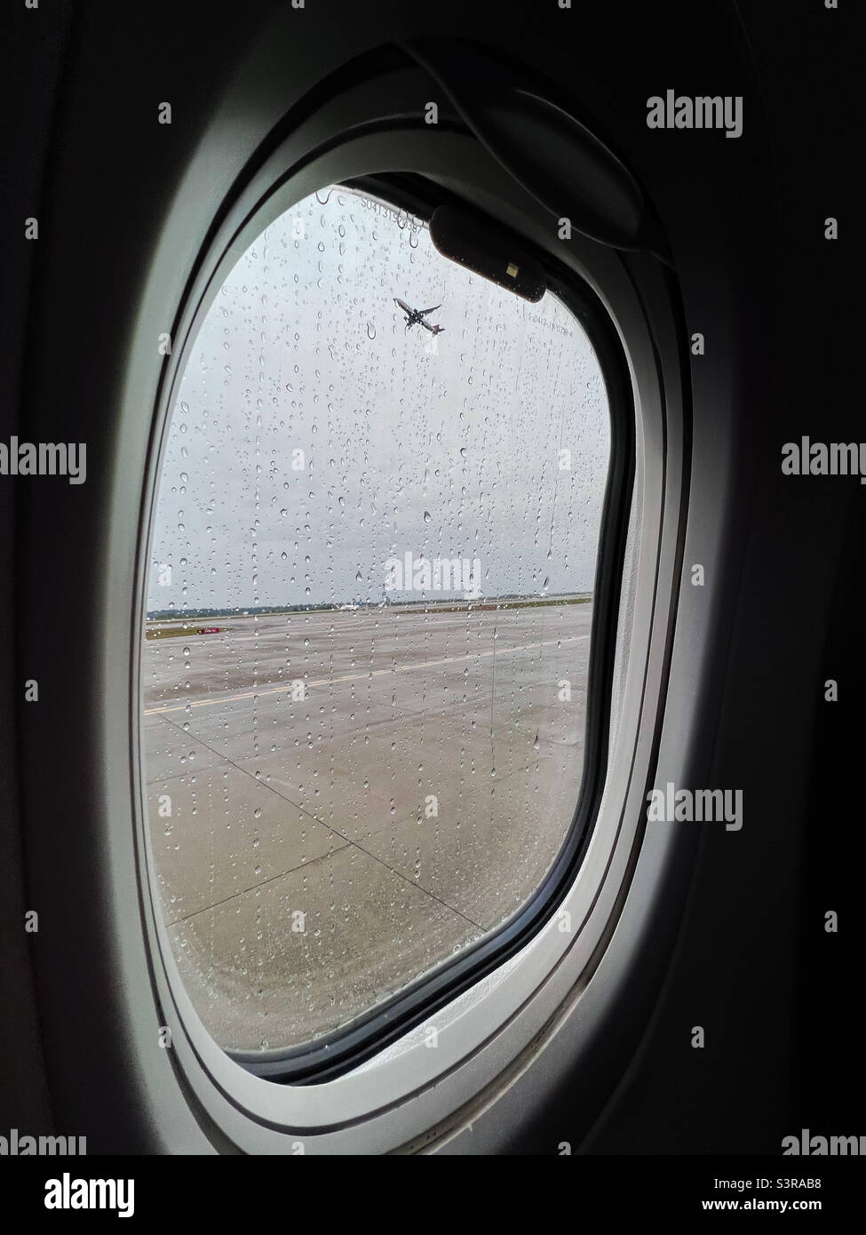 Rainy airplane departure in Seattle. - Smartphone Captured Stock Image