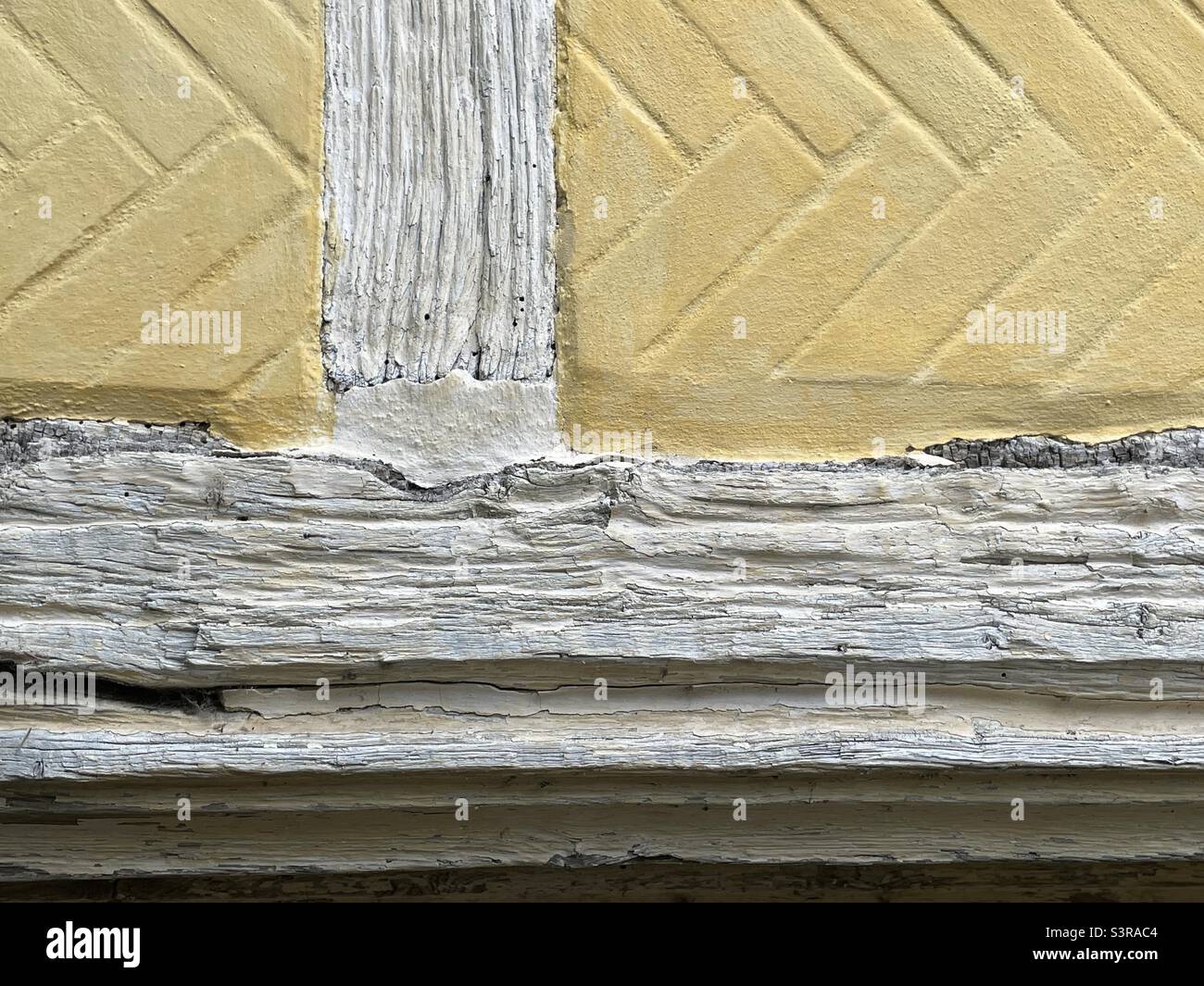 A detail of the exterior of the Chantry house in Henley on Thames showing weathered timbers and herringbone brickwork - Smartphone Captured Stock Image