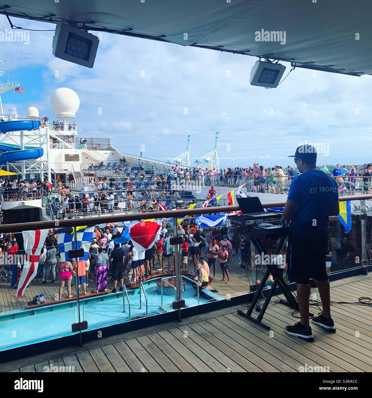March, 2022, DJ at the Sailaway Party for the Carnival Conquest cruise ship leaving Miami, Florida for a Bahamas cruise - Smartphone Captured Stock Image