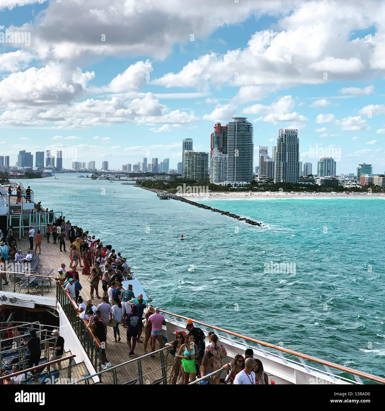 March, 2022, people on a cruise ship looking towards the South Beach skyline while sailing away from Miami, Florida, United States - Smartphone Captured Stock Image