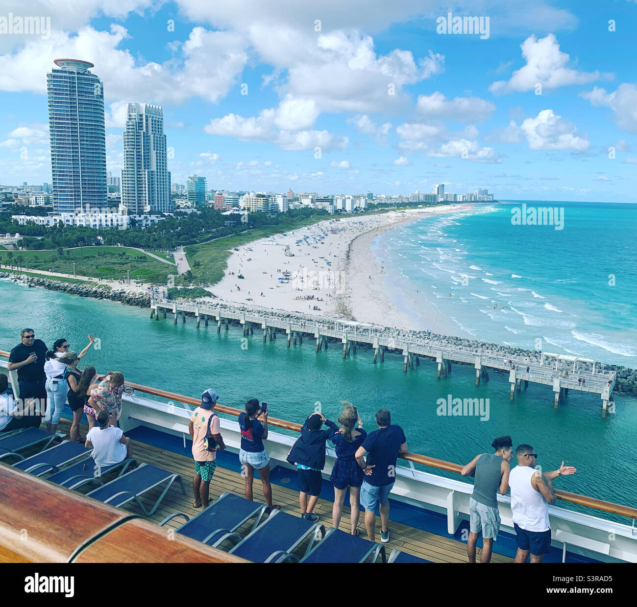 March, 2022, people take in views of South Pointe, South Beach, Miami Beach, from the deck of a cruise ship leaving the Port of Miami Stock Photo