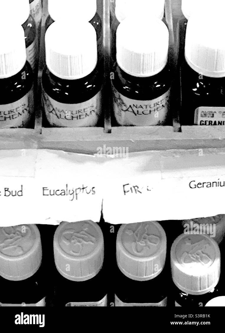 Black and White Selection of Small Vials Containing Essential Oils Stock Photo