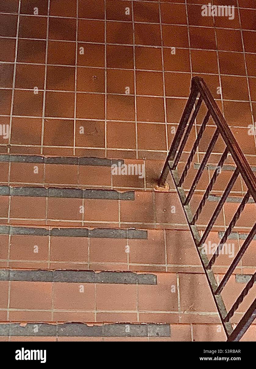 Red Brick Steps and Flooring with Black Handrail and Negative Space - Smartphone Captured Stock Image