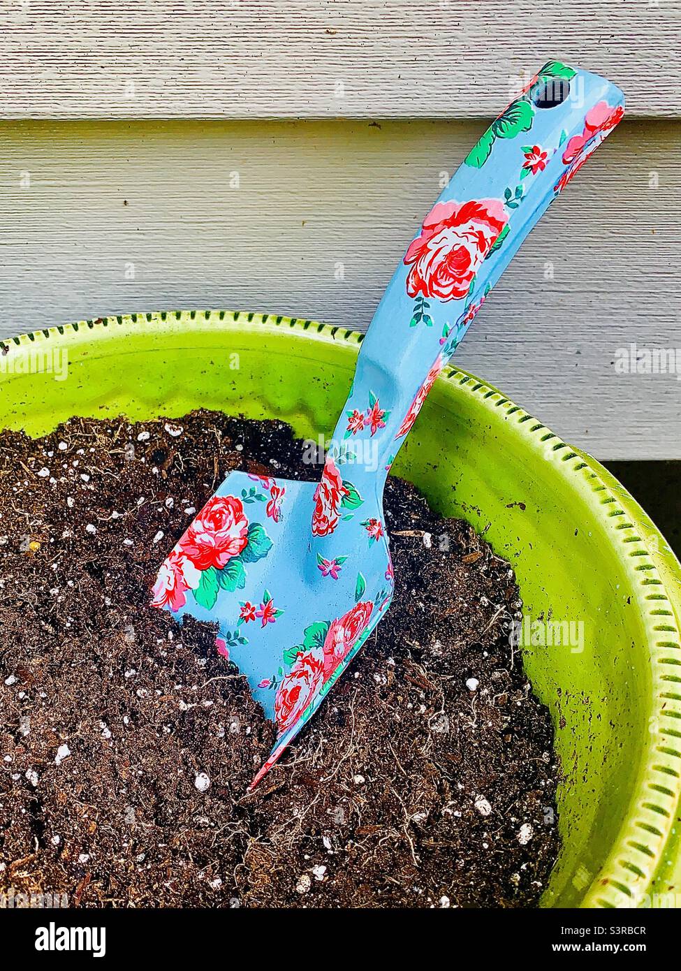 Garden Soil in Bright Green Pot with Floral Trowel - Smartphone Captured Stock Image