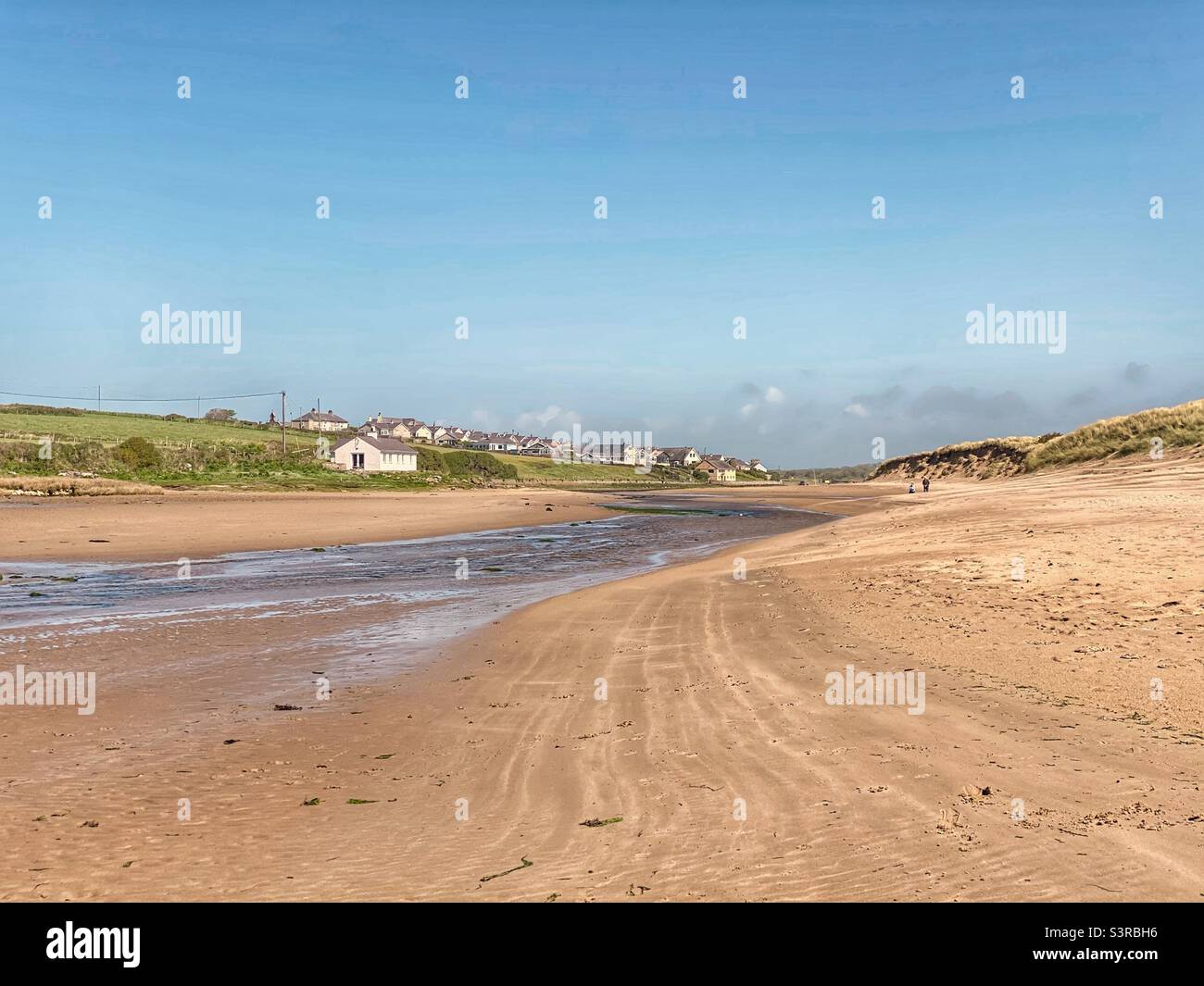 Aberffraw beach landscape on a sunny day in May, near the channel of water and sand dunes - Smartphone Captured Stock Image