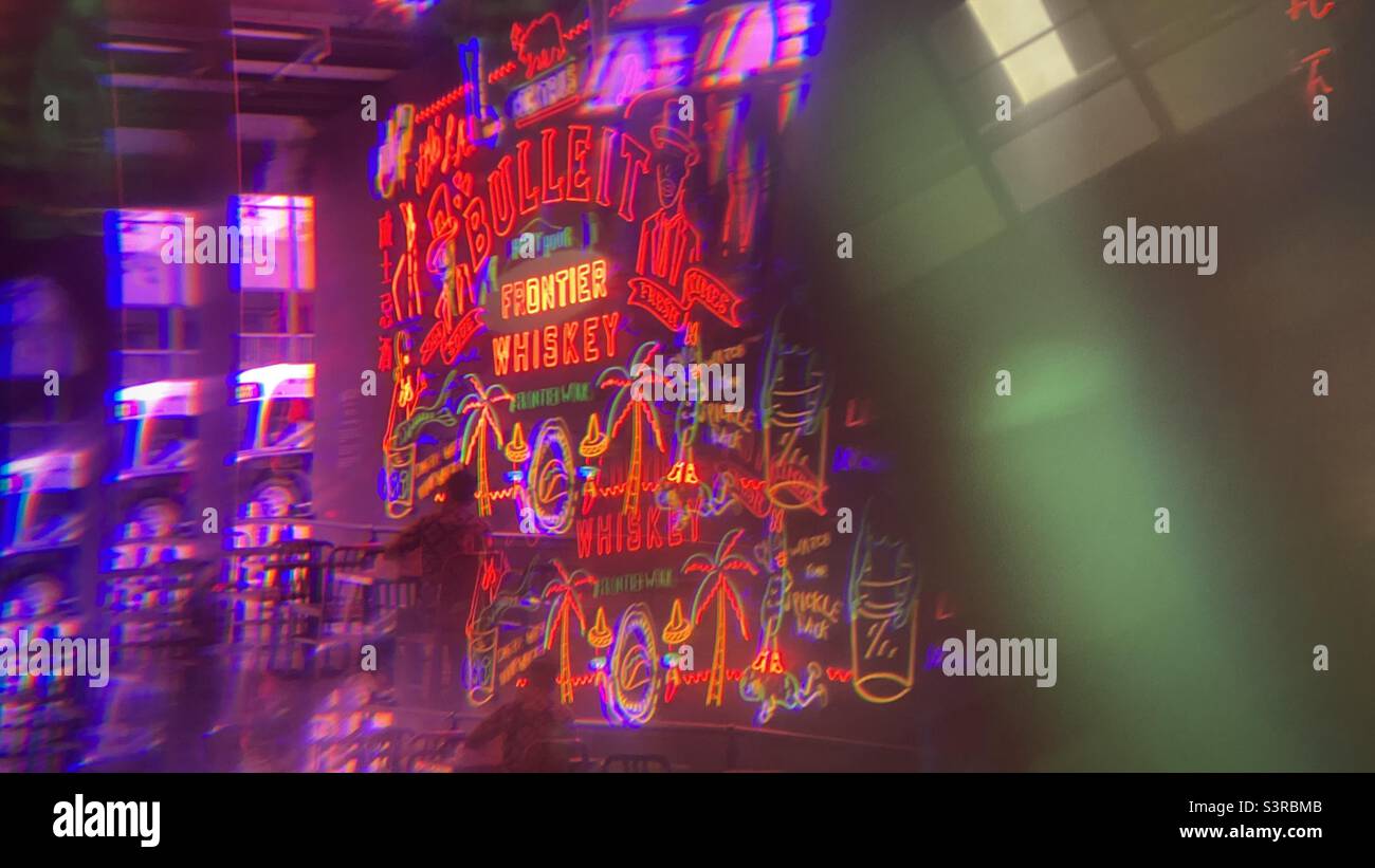 LOS ANGELES, CA, AUG 2021: abstract pattern created with prism viewing Bulleit Frontier Whiskey neon sign and nearby entrance at Grand Central Market in Downtown - Smartphone Captured Stock Image