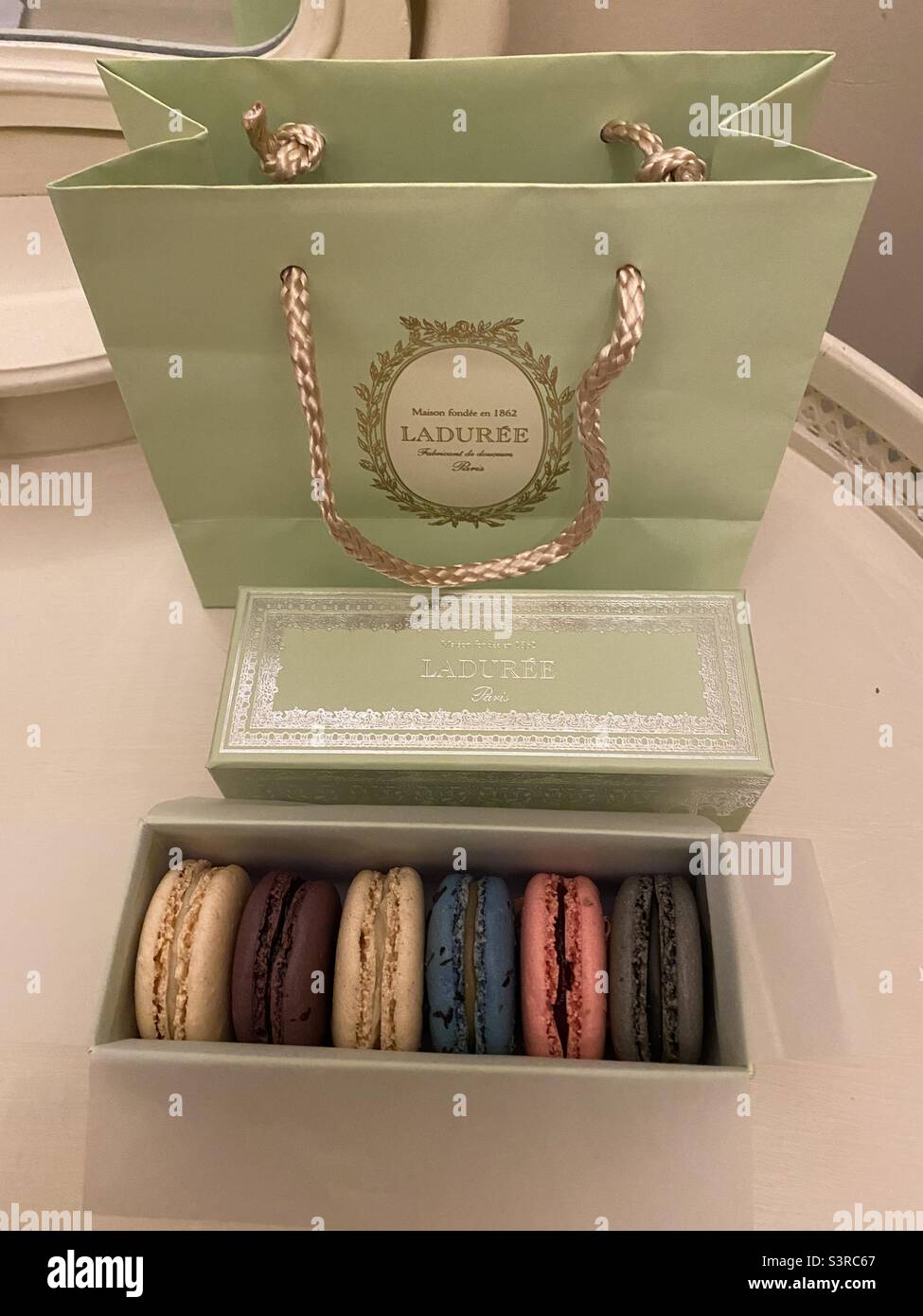 A box of macarons from Ladurée, with a bag. April 2022. - Smartphone Captured Stock Image