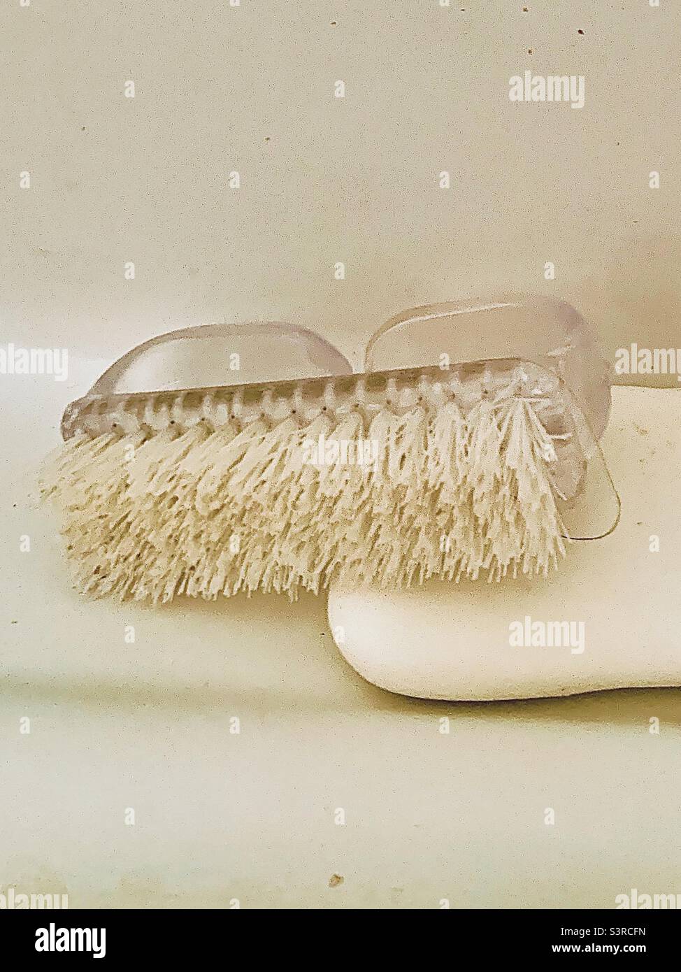 White bar of soap and scrub brush on white background with negative space Stock Photo