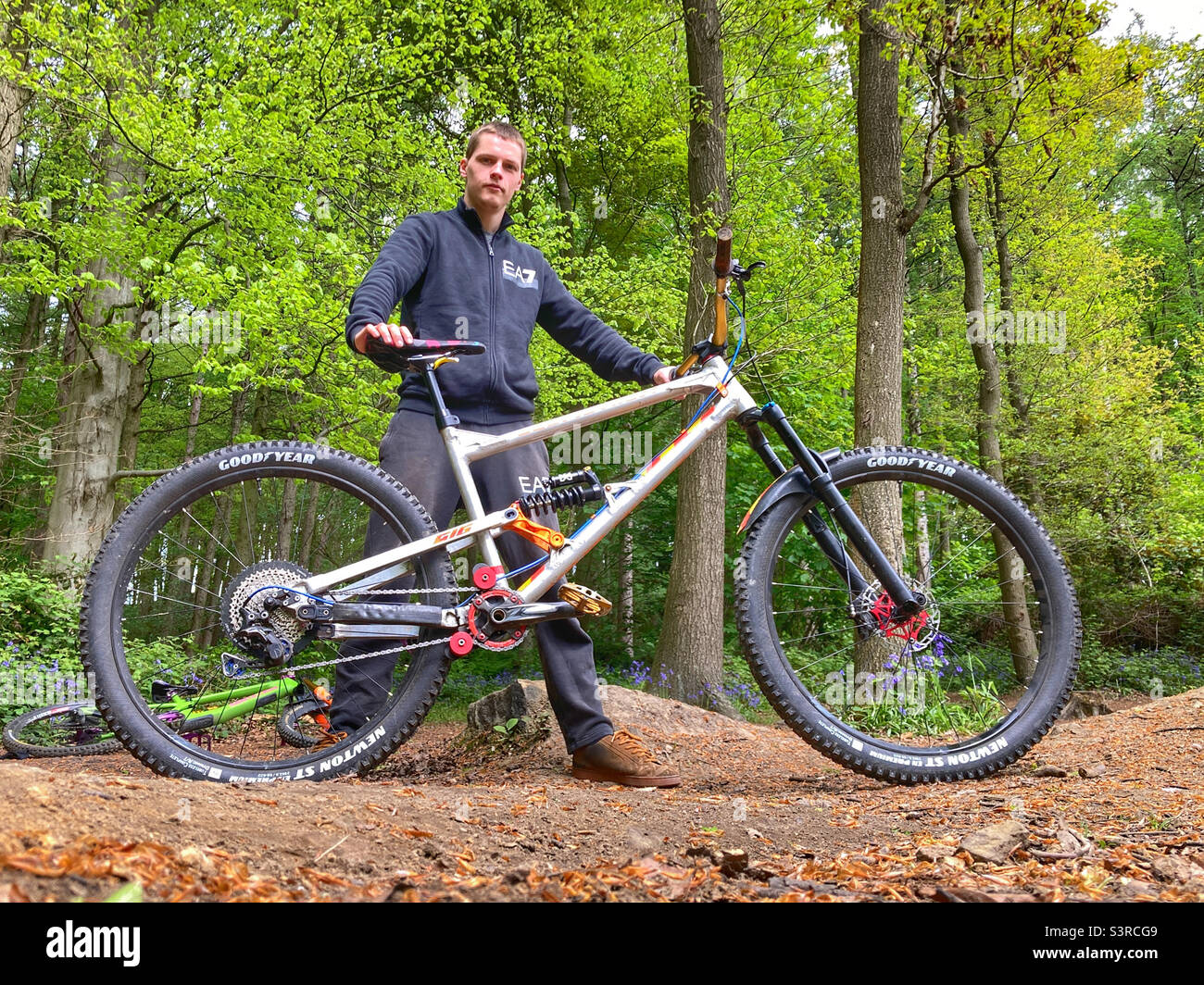 Mountain biker posing with his Downhill bike in Esholt woods West Yorkshire - Smartphone Captured Stock Image
