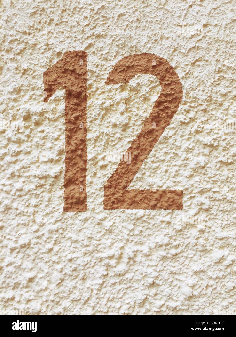 Number twelve painted on the facade of a house - Smartphone Captured Stock Image