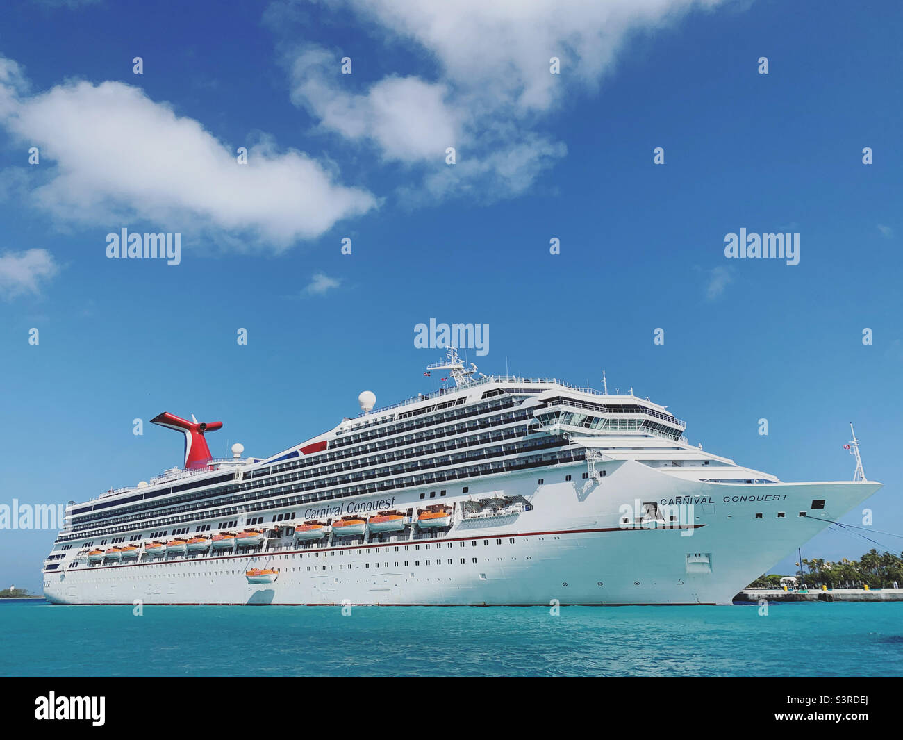 March, 2022, Carnival Conquest, in port in Nassau, Bahamas during a cruise from Miami, Florida, United States - Smartphone Captured Stock Image