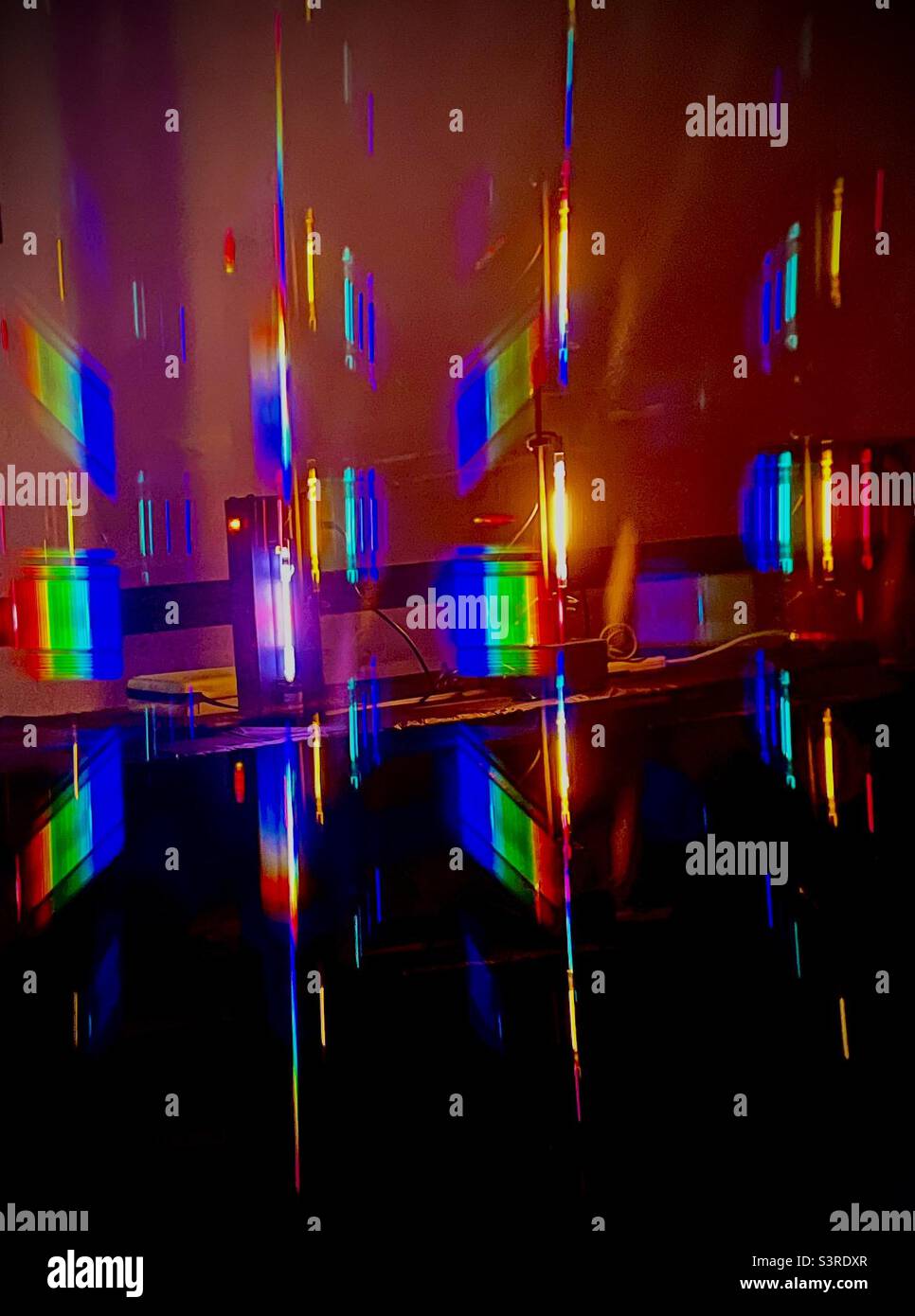 Spectral display. Gas discharge tubes and light fixture display a rainbow of colors. Stock Photo