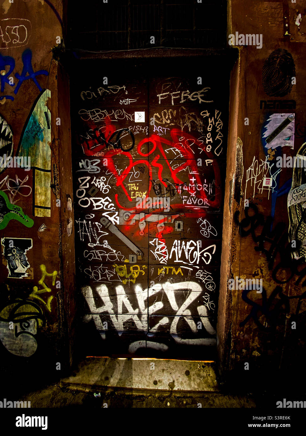 Graffitied, gritty, locked entryway to a possibly abandoned building Stock Photo
