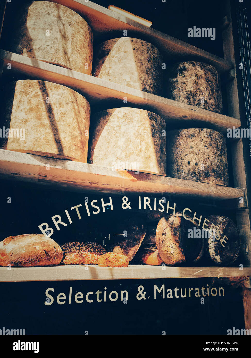 A selection of British and Irish Cheeses in the window of Neal’s Yard Dairy at Borough Market, London. Stock Photo