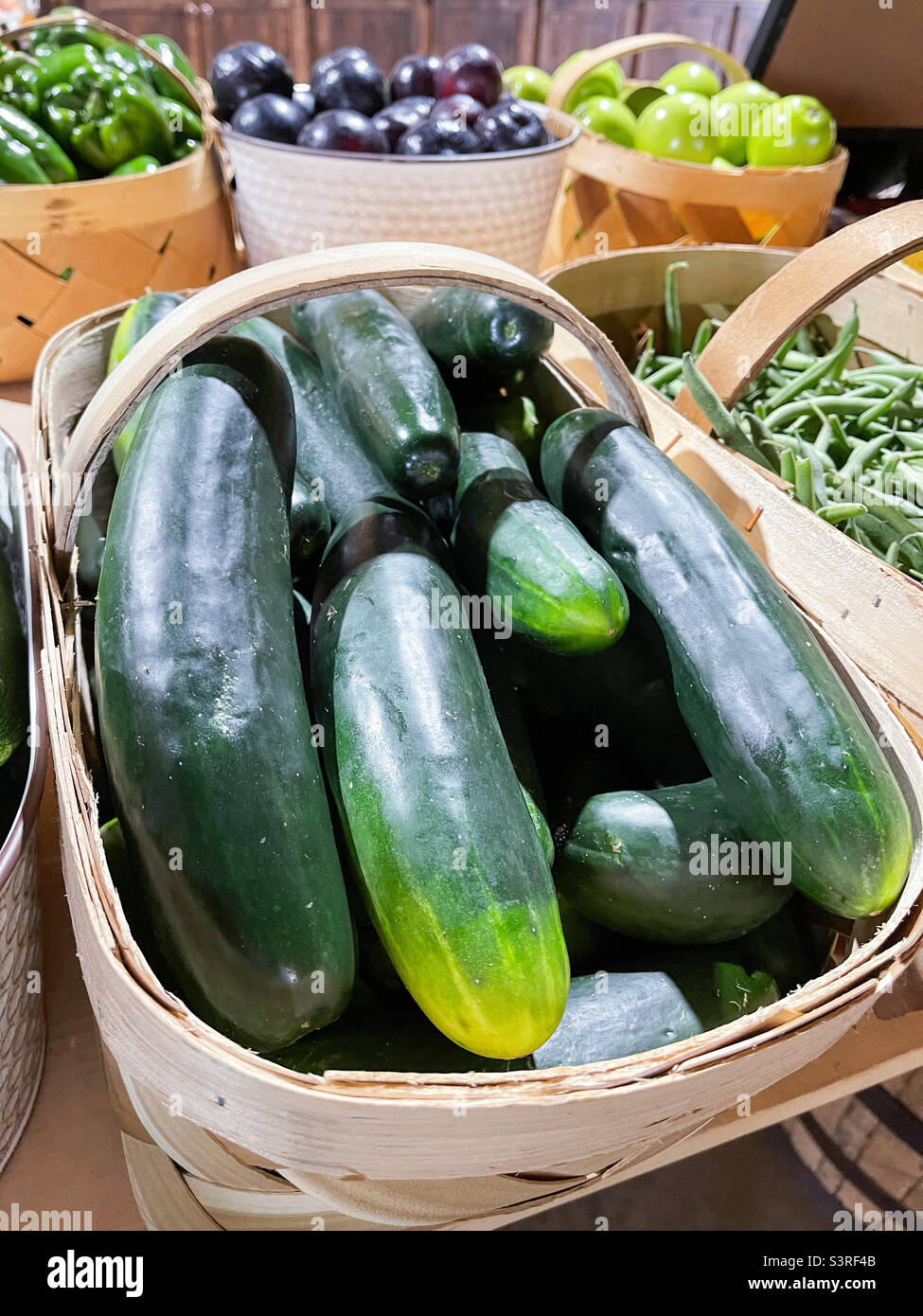 Just picked fresh whole cucumbers for sale at a farmers market Stock