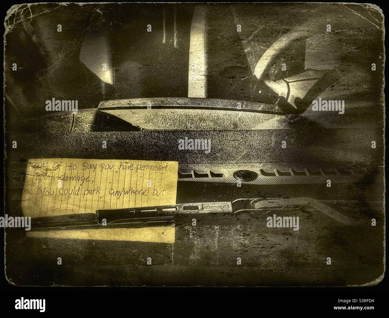 A nasty note left on the windshield of a Utah driver, accusing him of brain damage simply because they didn’t like where he parked. Digitally added grunge and antique effects. - Smartphone Captured Stock Image
