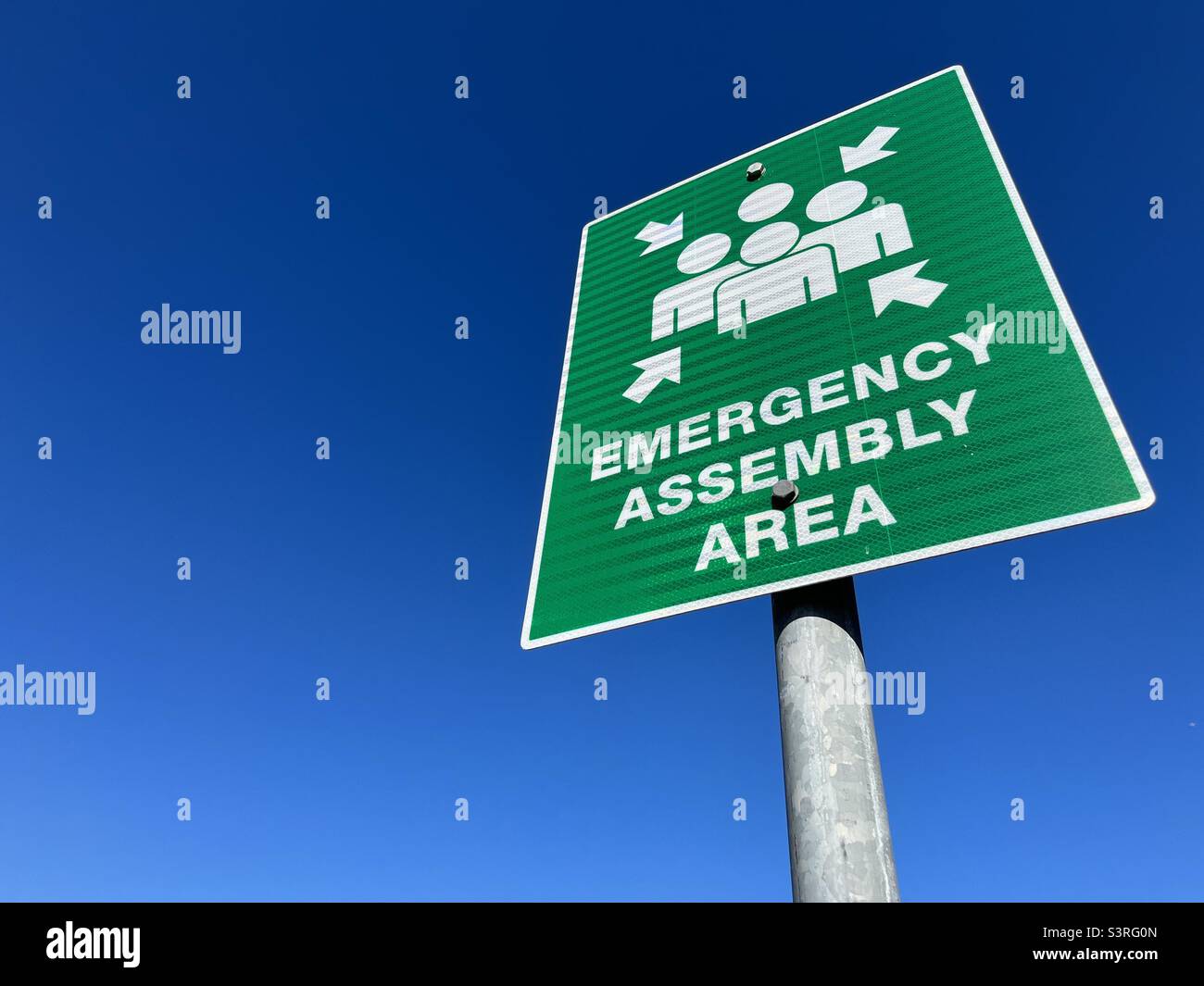 Emergency assembly area sign against blue sky - Smartphone Captured Stock Image Emergency assembly area sign against blue sky - Smartphone Captured Stock Image