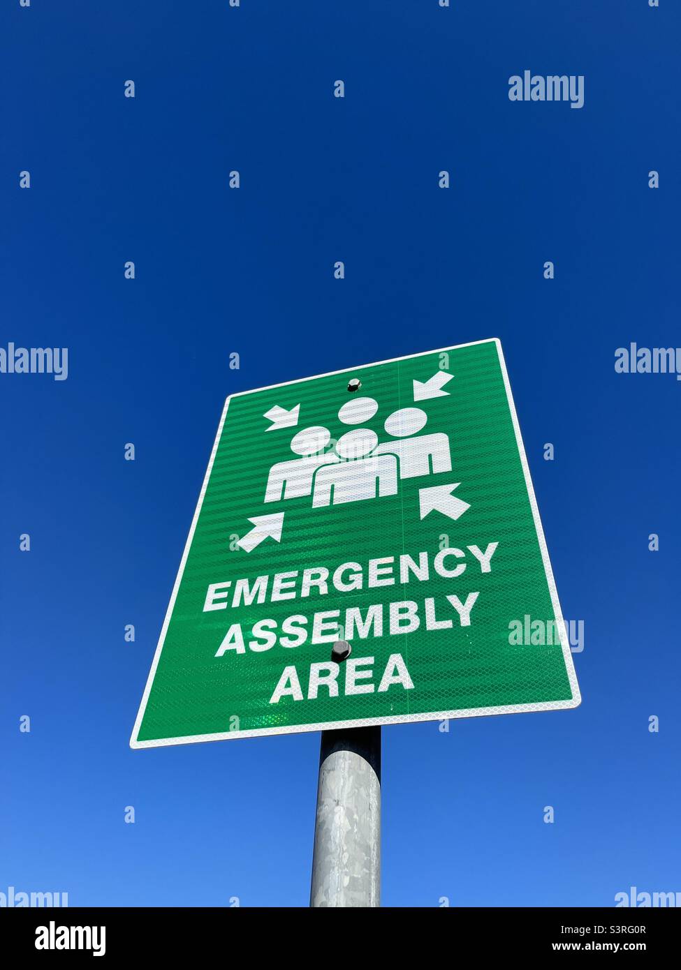 Emergency assembly area sign against blue sky - Smartphone Captured Stock Image Emergency assembly area sign against blue sky - Smartphone Captured Stock Image