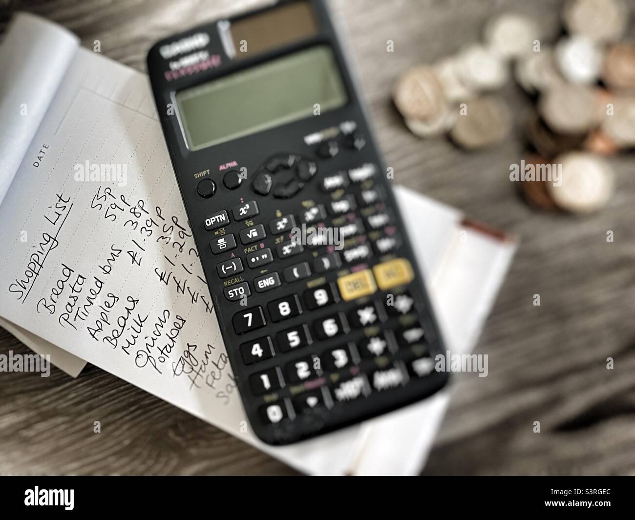 Cost of living crisis calculator, shopping list and loose change Stock