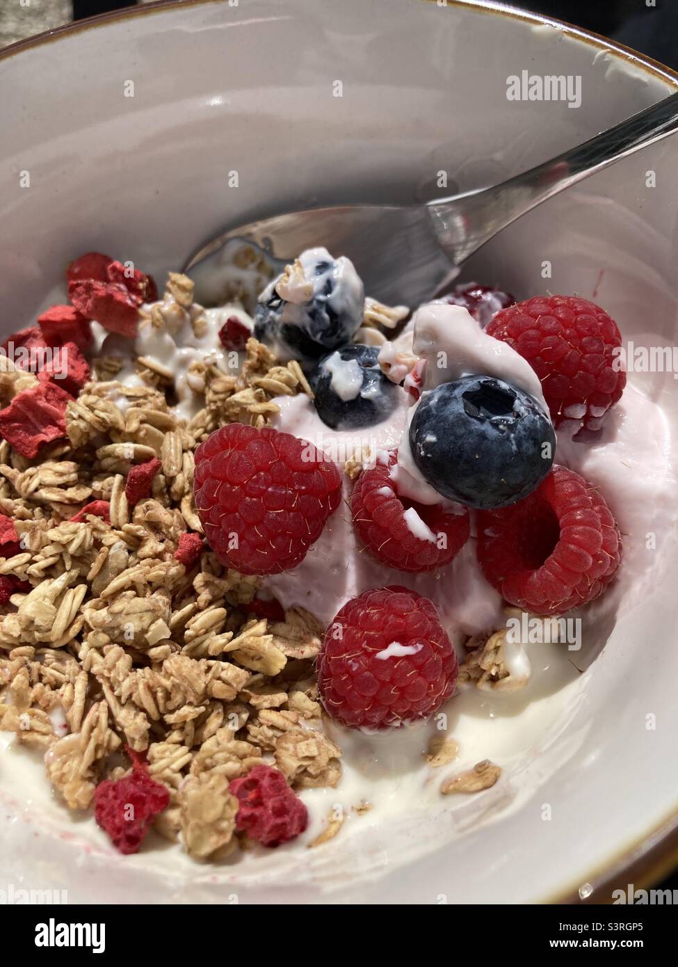 Berries and granola on yoghurt Stock Photo