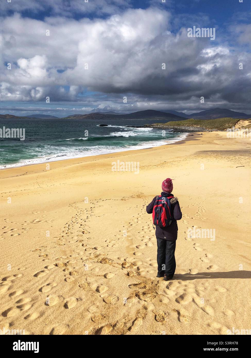 Hiker on Traigh Mhor at Borve, Sandy beach on the Isle of Harris, Scotland - Smartphone Captured Stock Image