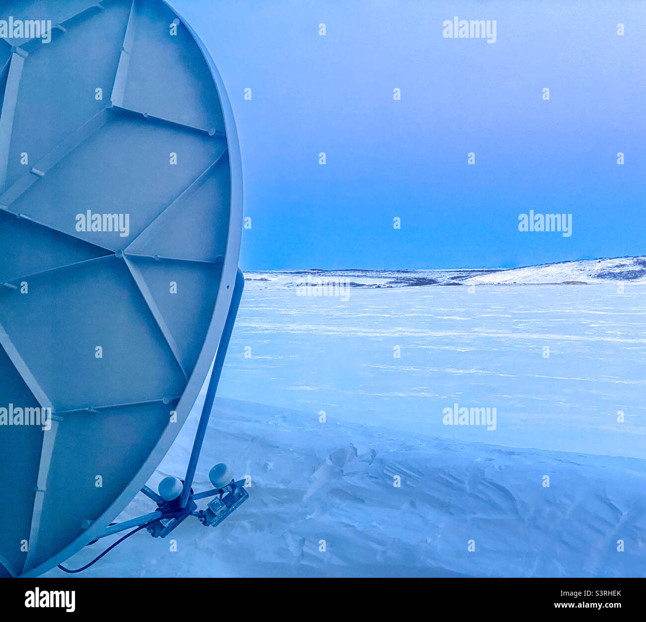 Home Satellite dish in the frozen Alaskan Arctic. Kotzebue, Alaska Stock Photo