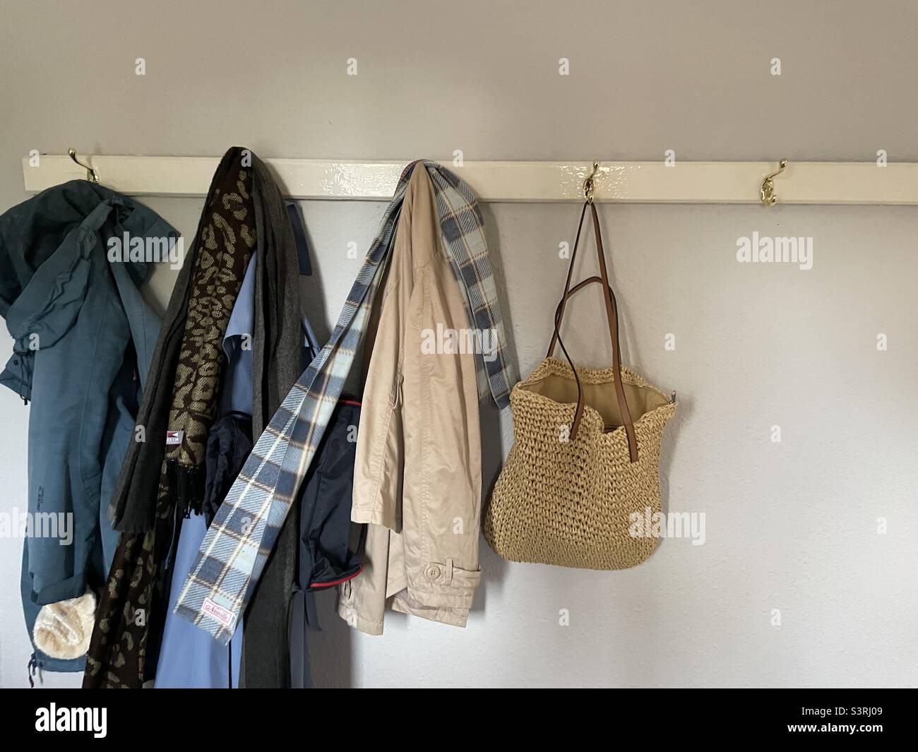 Coats and bags hanging up Stock Photo