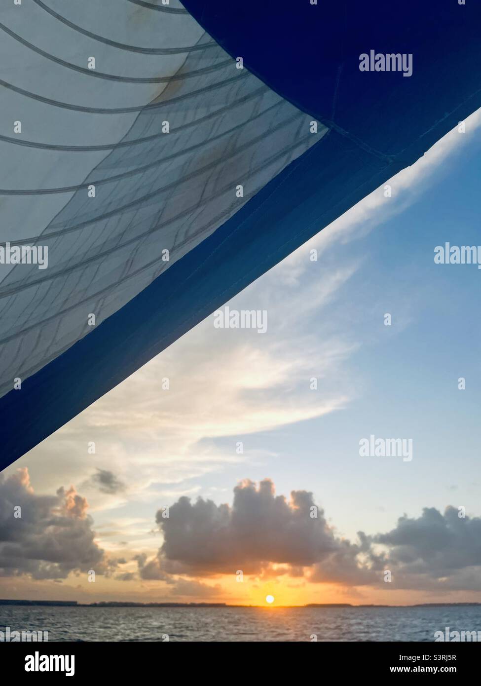 Sunset through the sails towards Cancun, Mexico in April - Smartphone Captured Stock Image
