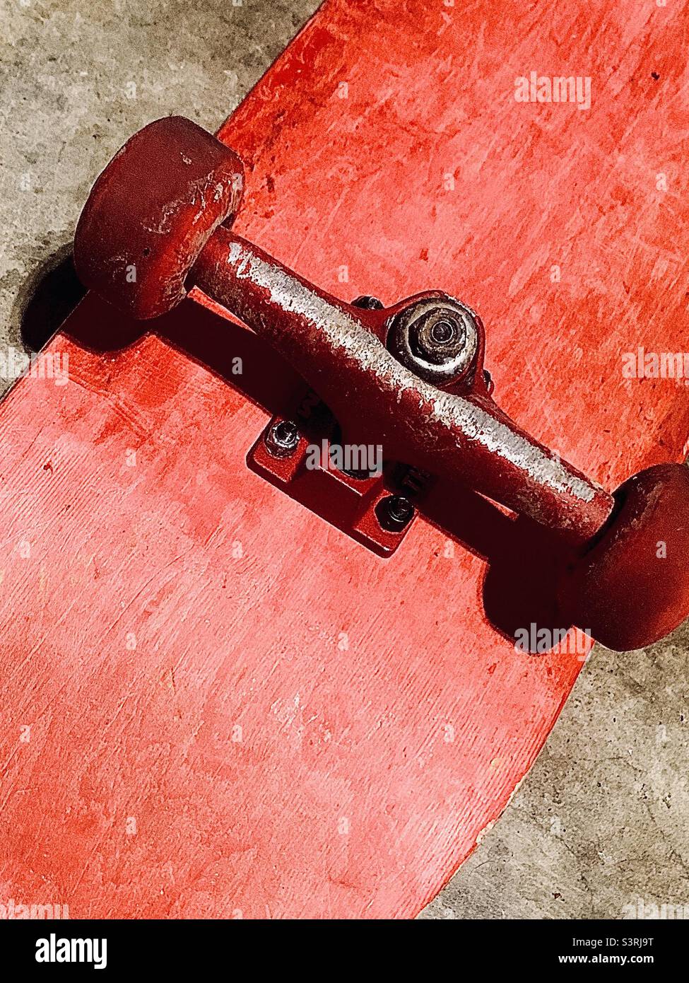 Diagonal bright red upside down skateboard - Smartphone Captured Stock Image