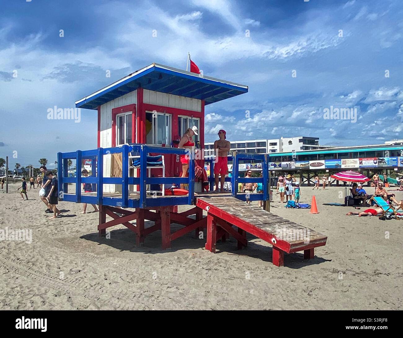 Lifeguards standing on their tower Stock Photo