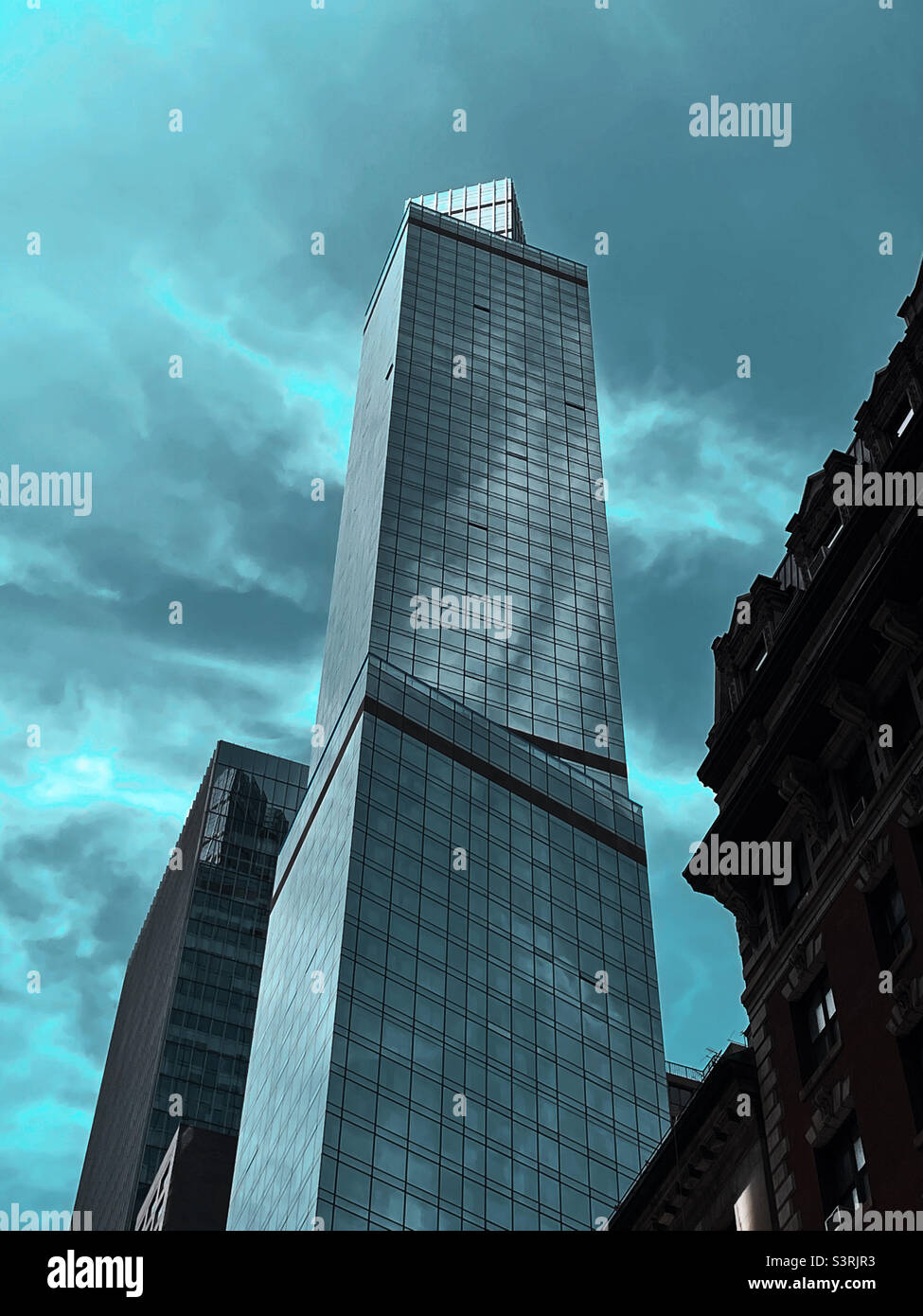 A towering modern glass covered courtyard by Marriott hotel skyscraper in Midtown Manhattan, 2022, New York City - Smartphone Captured Stock Image