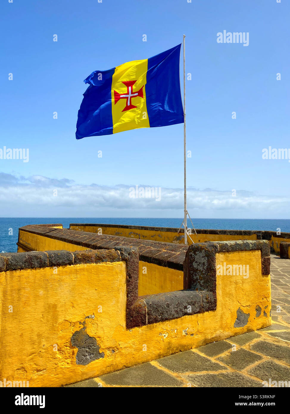 The flag of Madeira flies proudly @ Forte de Sâo Tiago in Funchal, Madeira. The flag was adopted 28th July 1978. This famous fort was constructed in the 17th Century and is a famous Funchal landmark. Stock Photo