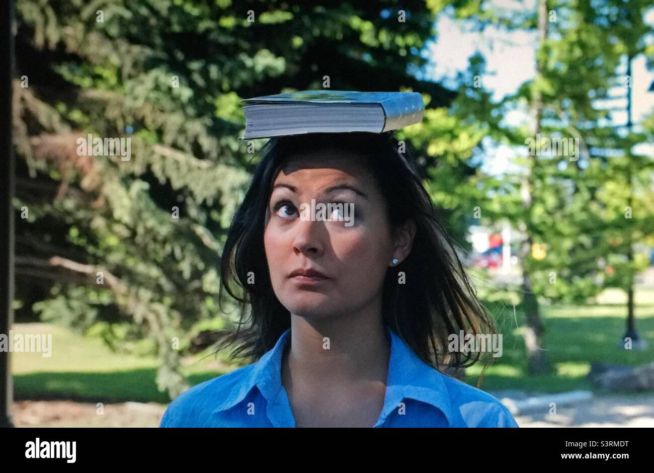 Balancing the book, book, woman, girl, lady, female, steady, pretty, park, outdoor, brunette, head, face, pretty - Smartphone Captured Stock Image