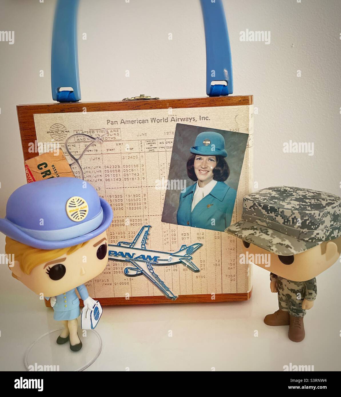 Vintage historical memorabilia on a cigar box purse from a Pan Am flight attendant along with two Funko pop characters, 2022, USA Stock Photo