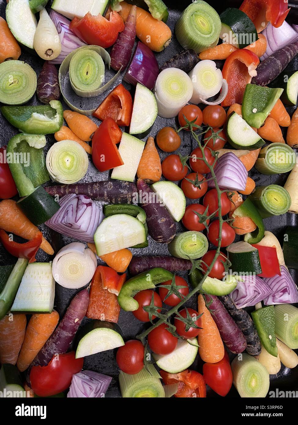 Cut vegetables in roasting tray healthy eating bright colours Stock