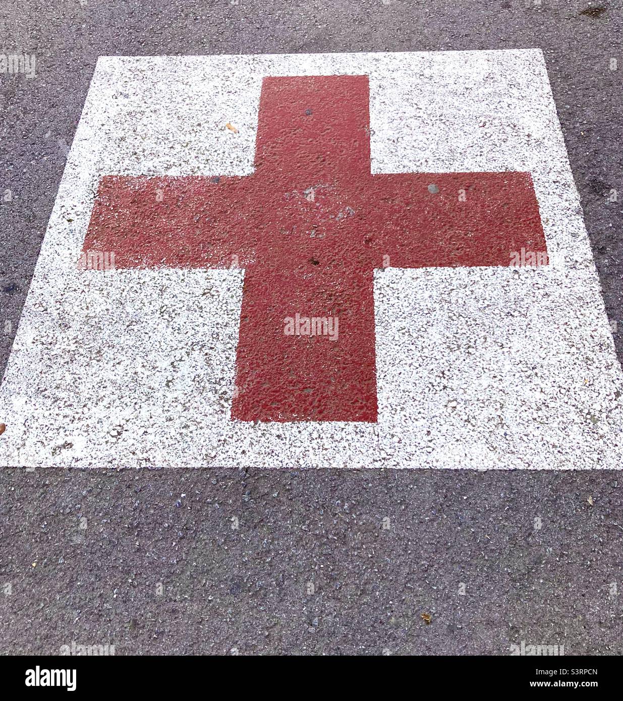 Red Cross on the ground in a parking space reserved for emergency services - Smartphone Captured Stock Image