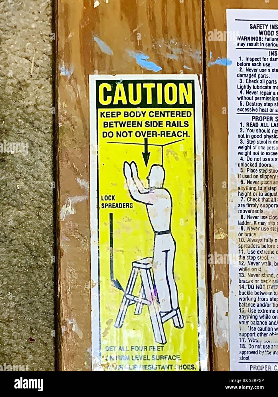 Caution sign on wooden ladder - Smartphone Captured Stock Image