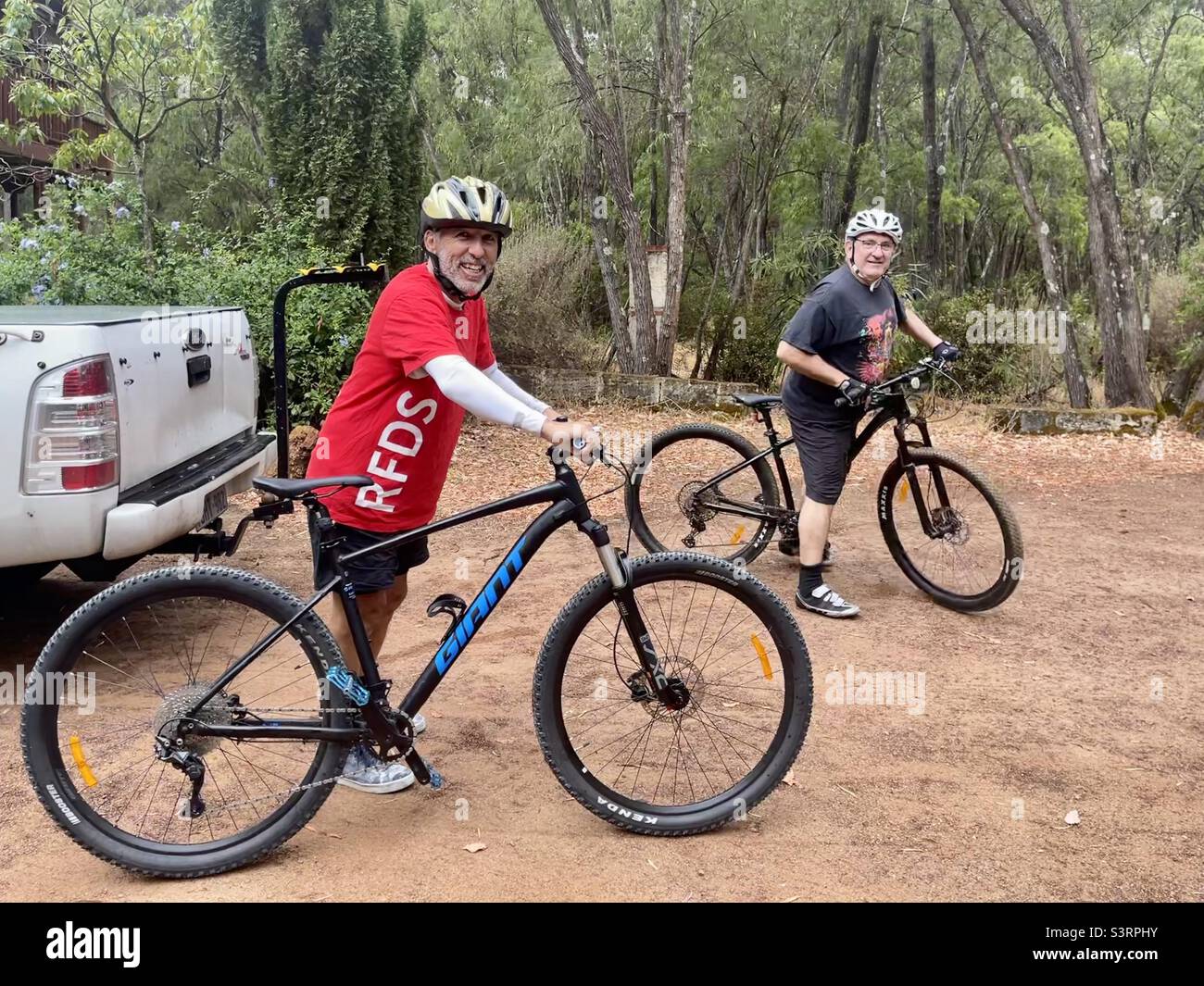 Two cyclists and mountain bikes on Wadandi rail trail cycling and
