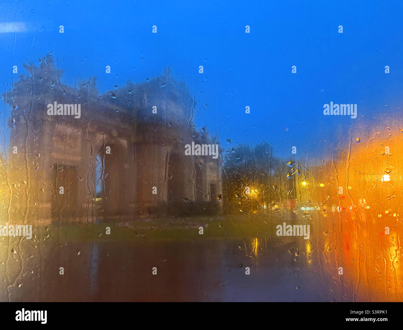 Alcala Gate viewed through a wet glass, night view. Madrid, Spain. - Smartphone Captured Stock Image