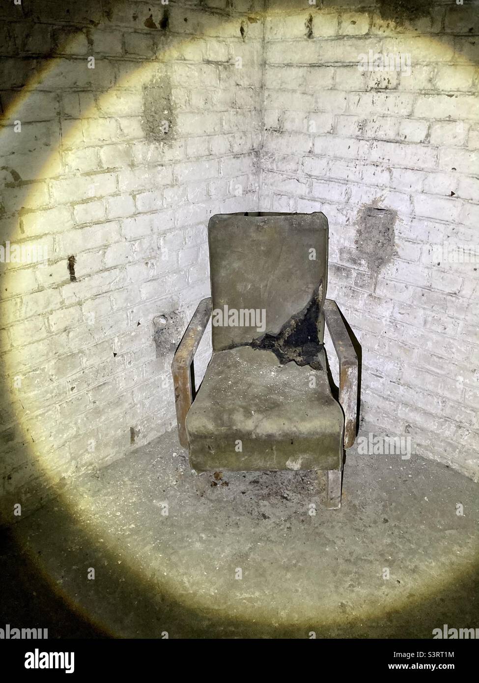 An old chair in an abandoned military position underground - Smartphone Captured Stock Image