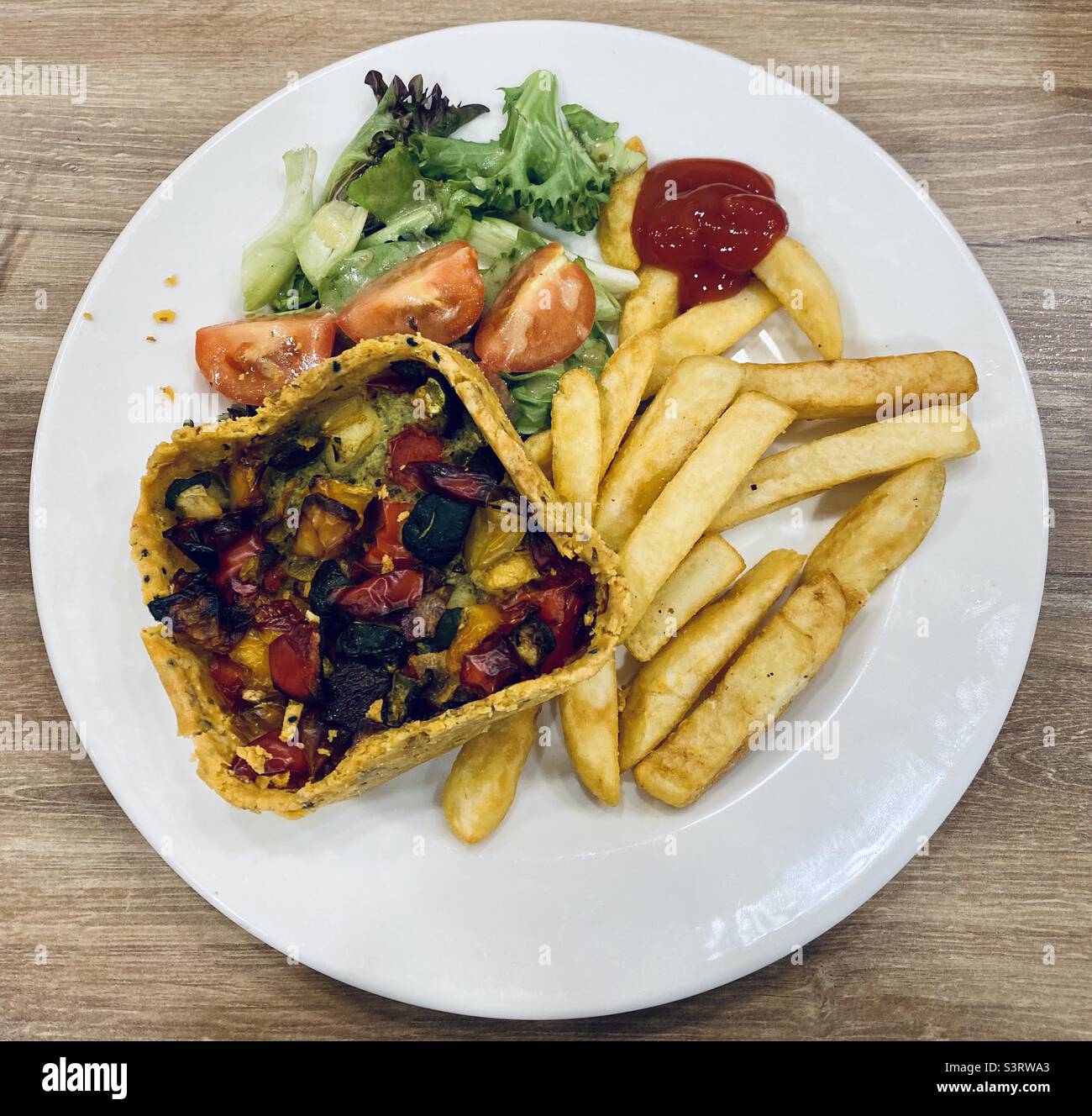 Vegetable tartlet with chunky chips, side salad and a dollop of tomato