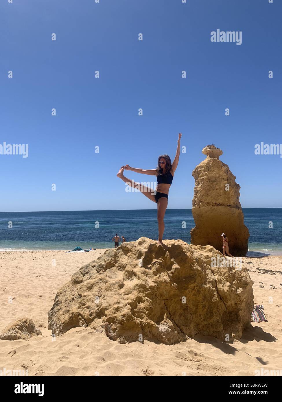 Woman balancing on rock in Portugal - Smartphone Captured Stock Image